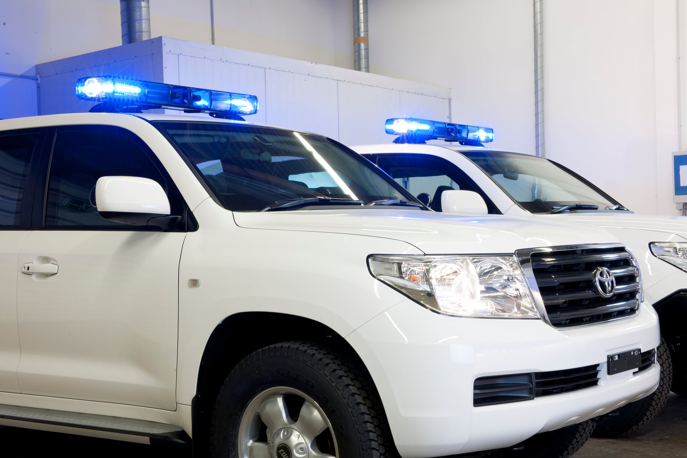 Armored Toyota Land Cruiser SUVs with roof light bars in the plant