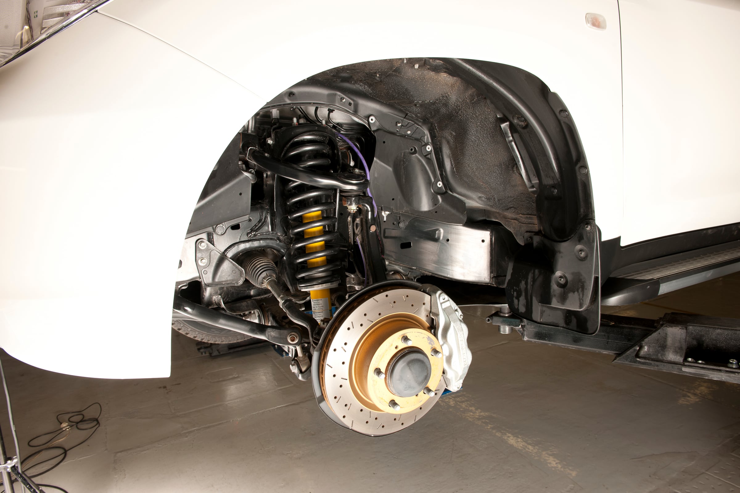 Reinforced front suspension and upgraded brakes of an armored Toyota Land Cruiser